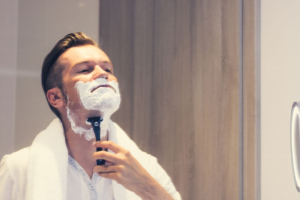 man shaving with shampoo