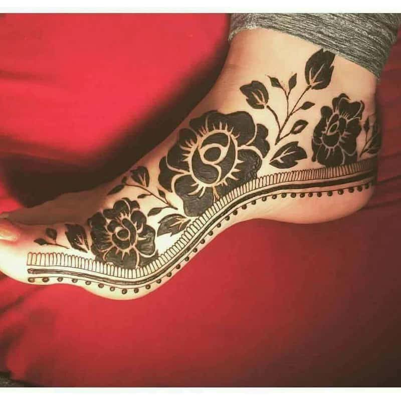 rose motif henna design on feet